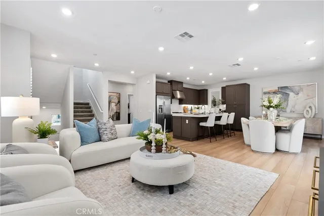 a living room with furniture kitchen and a table