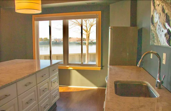 a bathroom with a tub a sink and a window