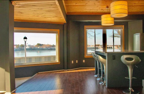 a view of a room with furniture and wooden floor