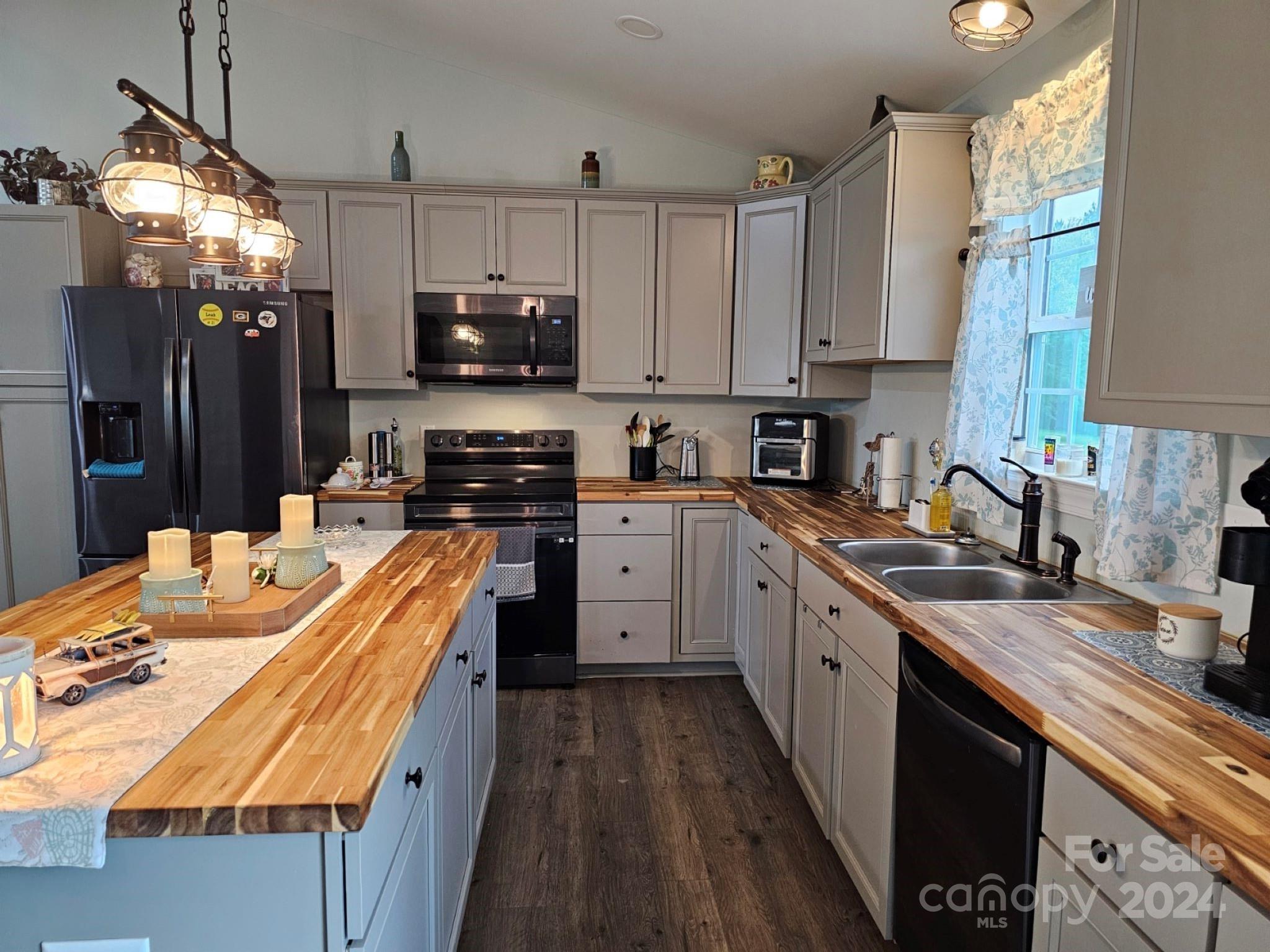 302 Flint Hill Road Cherryville, NC 28021 - Photo 13 of 32 a kitchen with kitchen island granite countertop a sink a stove oven a counter top space and cabinets