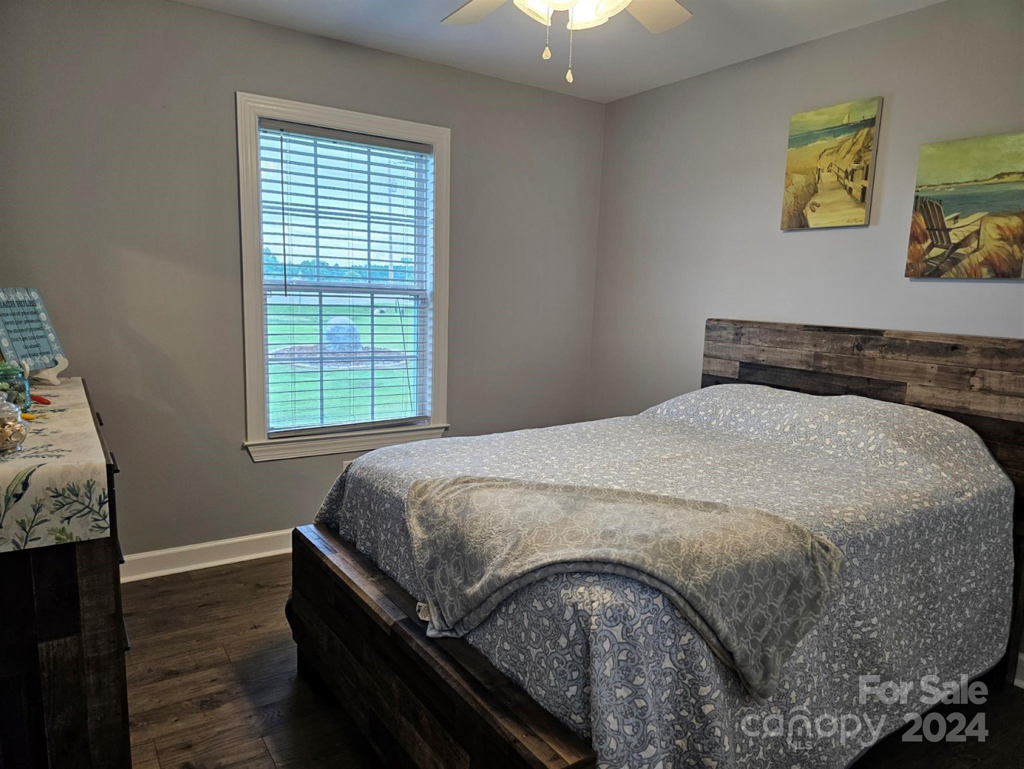 302 Flint Hill Road Cherryville, NC 28021 - Photo 17 of 32 a bedroom with a bed and wooden floor