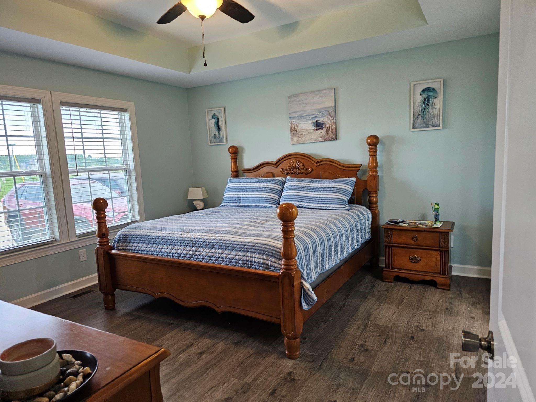 302 Flint Hill Road Cherryville, NC 28021 - Photo 24 of 32 a bedroom with a bed and a chandelier