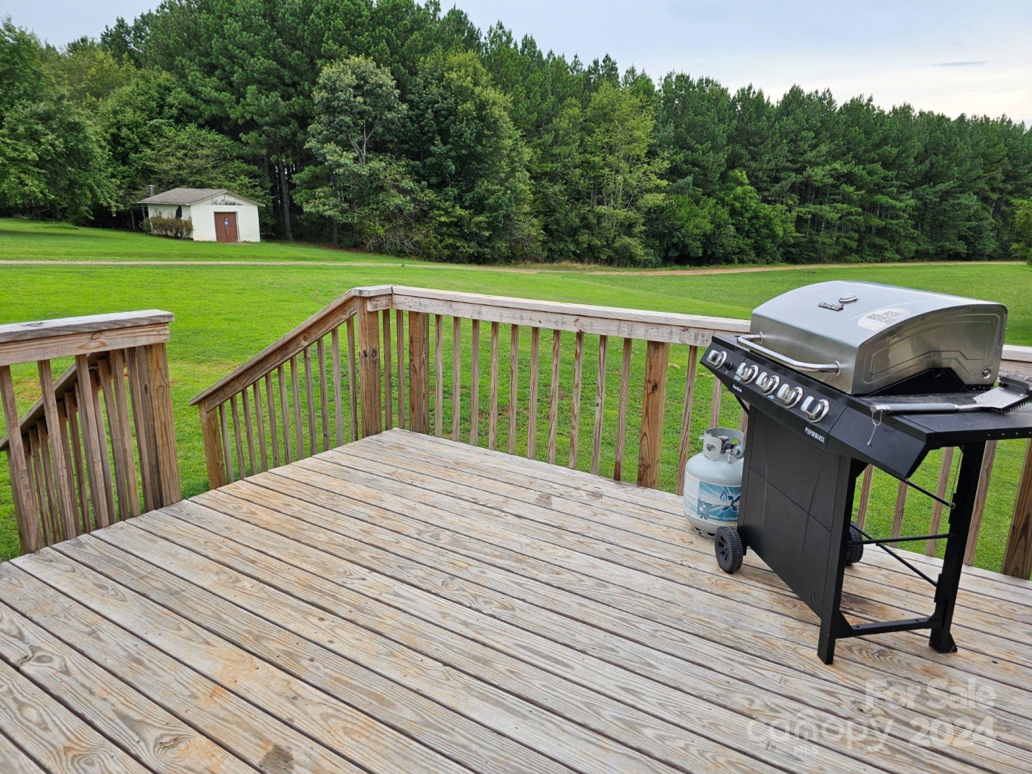 302 Flint Hill Road Cherryville, NC 28021 - Photo 30 of 32 a view of a deck with furniture and garden