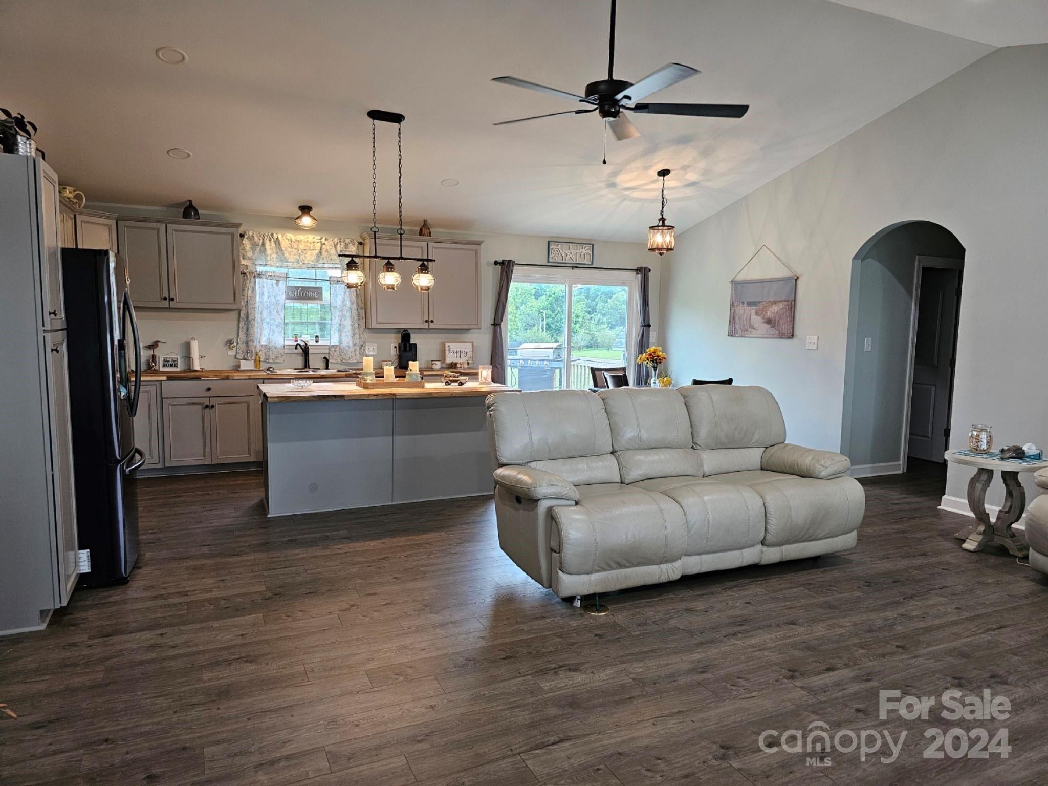 302 Flint Hill Road Cherryville, NC 28021 - Photo 6 of 32 a living room with stainless steel appliances granite countertop furniture a fireplace a flat screen tv and a window