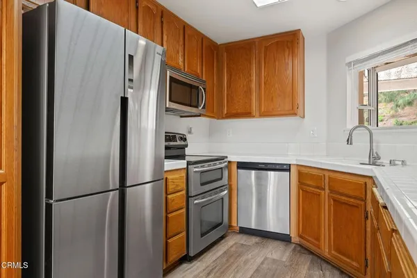 a kitchen with stainless steel appliances a refrigerator stove and sink