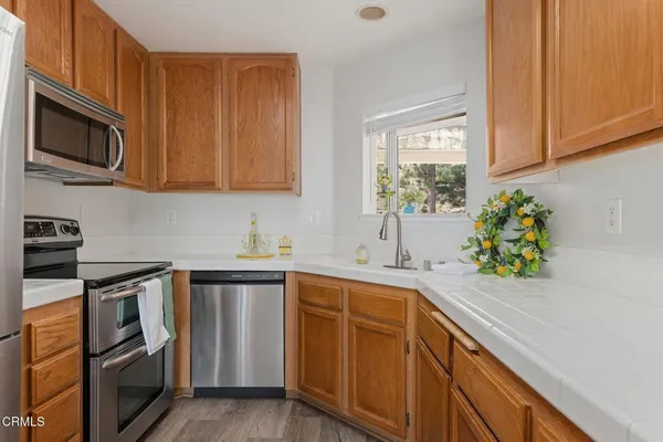 a kitchen with a sink cabinets and stainless steel appliances