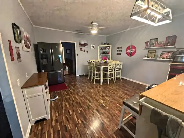 a view of a dining room with furniture kitchen and wooden floor