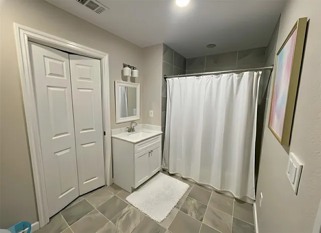 a view of a utility room with closet and mirror