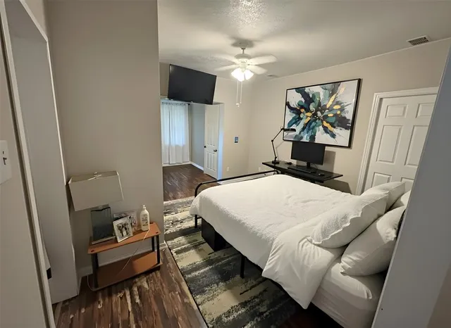 a bedroom with a bed and a flat screen tv