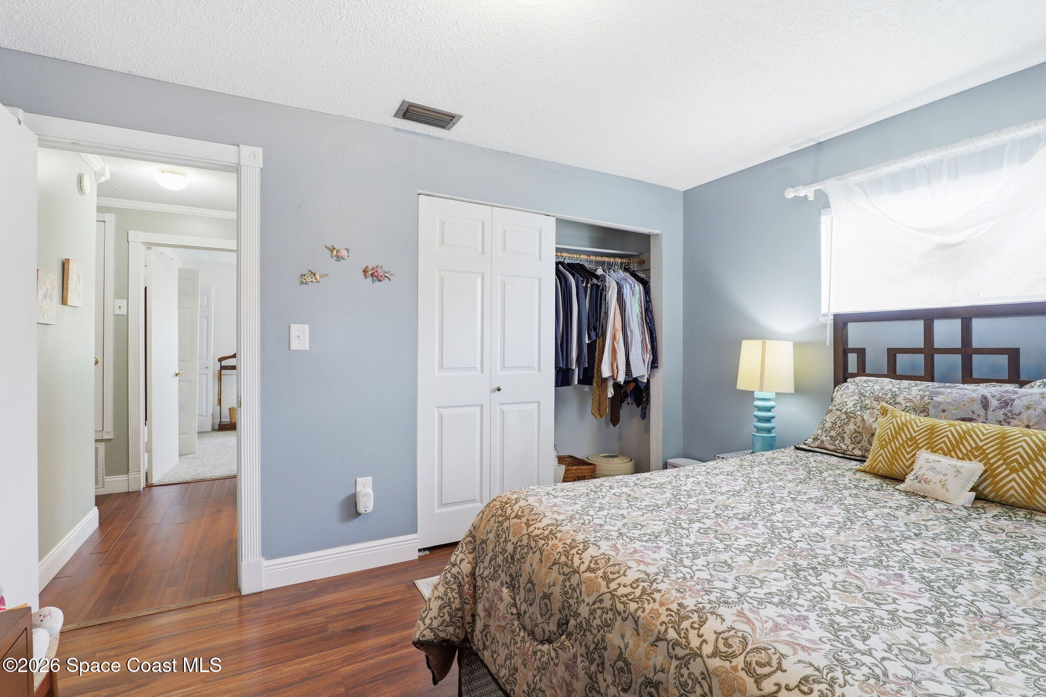 908 Jefferson Road Rockledge, FL 32955 - Photo 17 of 37 a bedroom with a bed and wooden floor