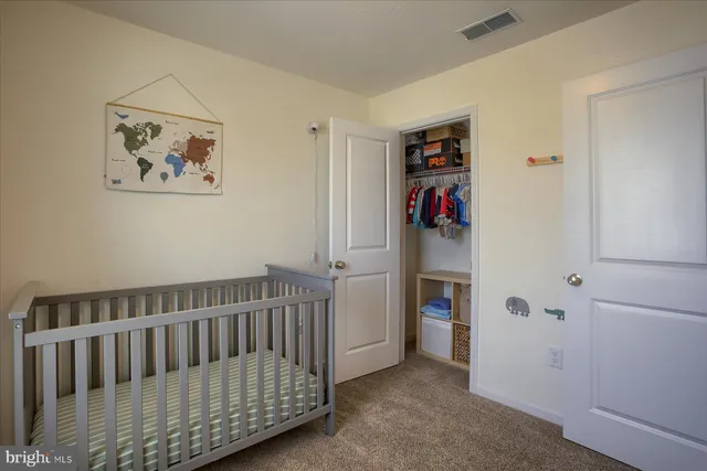 a view of a hallway with wooden floor and closet