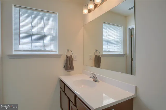 a bathroom with a sink and a window