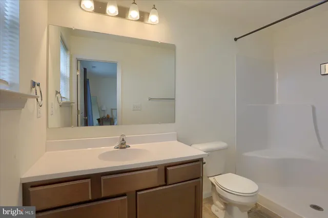 a bathroom with a sink toilet and a mirror
