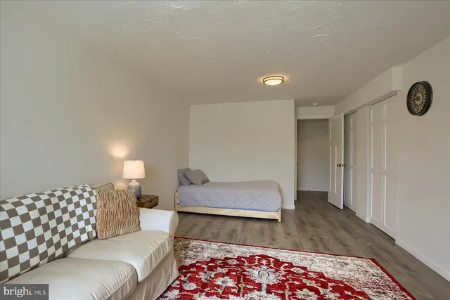 a bedroom with a bed and a couch