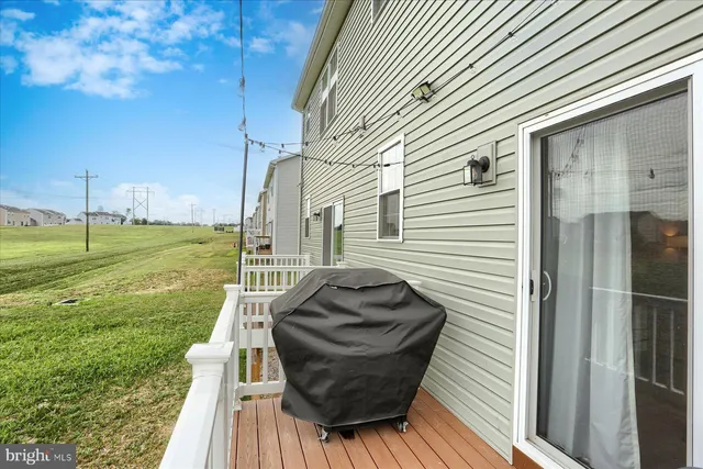 a view of a porch with furniture and a yard