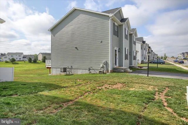 a backyard of a house with lots of green space and lake view