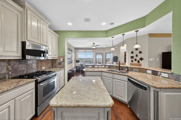 a kitchen with stainless steel appliances granite countertop a sink and stove