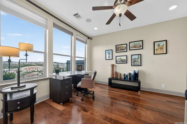 a living room with furniture and a floor to ceiling window