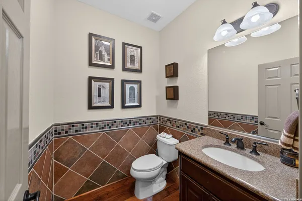 a bathroom with a sink a toilet and mirror