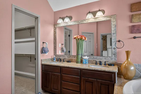 a bathroom with a double vanity sink and a mirror