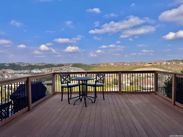 a view of a balcony with wooden floor and city view