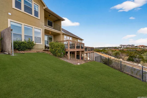 a view of a balcony with furniture and wooden floor