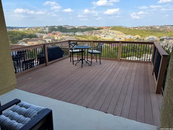 a view of a balcony with wooden floor and city view
