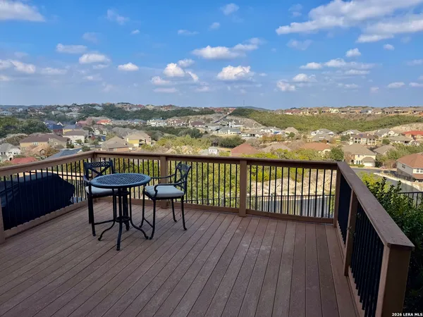 an aerial view of a swimming pool with outdoor seating