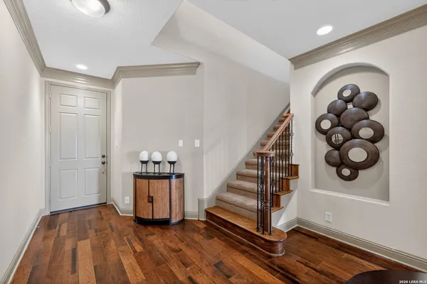 a view of a hallway with wooden floor and entryway