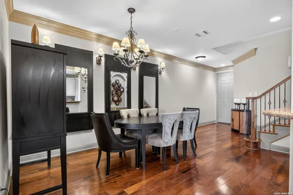a view of a dining room with furniture and chandelier