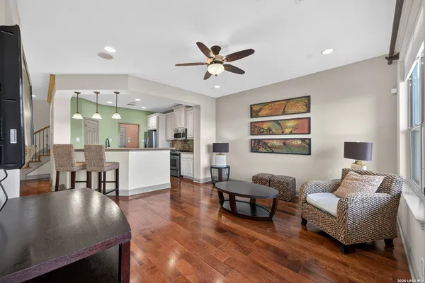 a living room with furniture and a view of kitchen