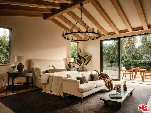 a bedroom with furniture and a large window