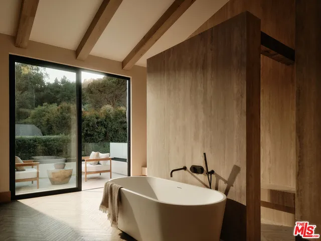 a spacious bathroom with a bathtub and next to a window