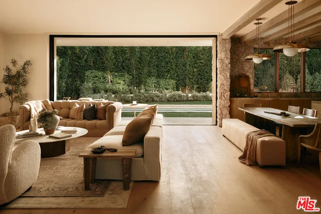 a living room with furniture and a floor to ceiling window