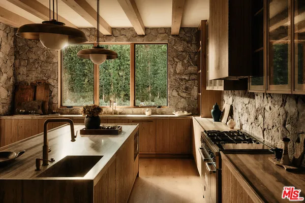 a kitchen with a sink a counter top space and a stove