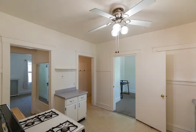a kitchen with a refrigerator and a chandelier