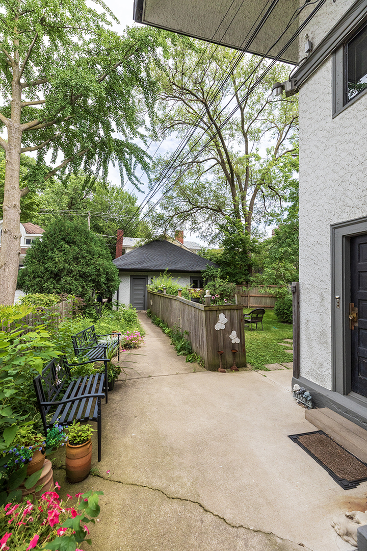 202 Ridgeland Avenue, Unit 2 Oak Park, IL 60302 - Photo 3 of 34 a view of a patio with table and chairs potted plants and large tree