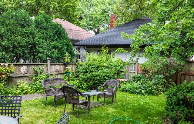 a view of a chair and table in the garden