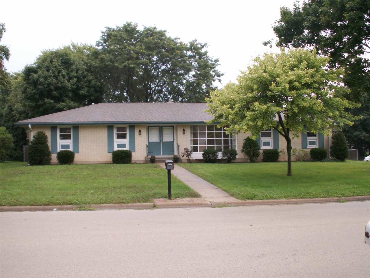 5407 Brookview Road Rockford, IL 61107 - Photo 1 of 16 a front view of a house with a yard and trees