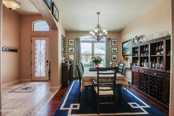 a kitchen with stainless steel appliances granite countertop a table and cabinets