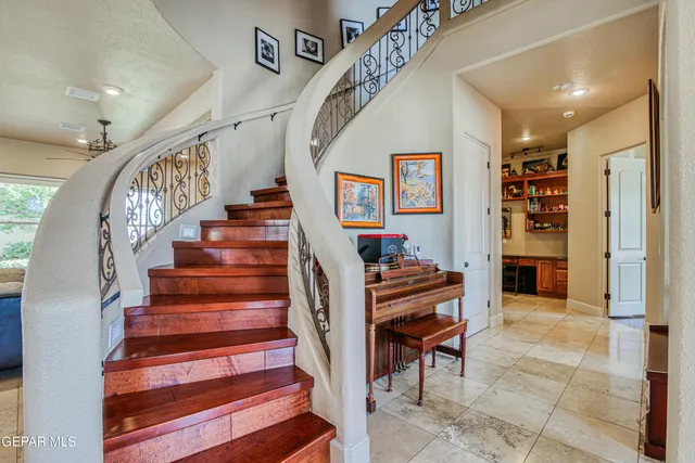 a bedroom with a large bed and a chandelier