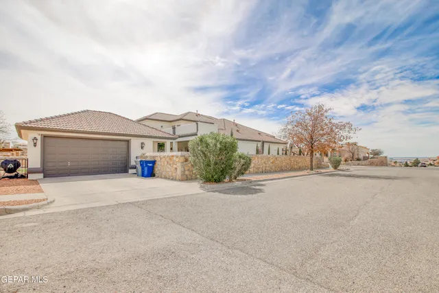 a view of a patio with table and chairs and potted plants