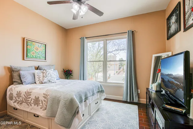 a spacious bathroom with a granite countertop sink and a mirror