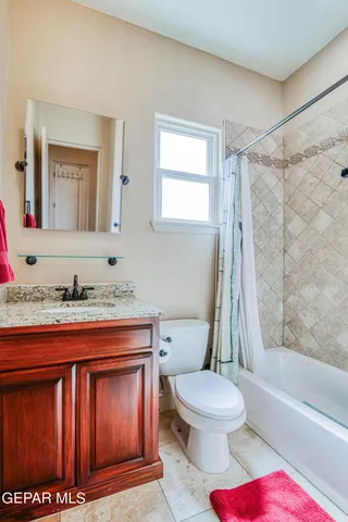 a spacious bathroom with a tub sink and mirror