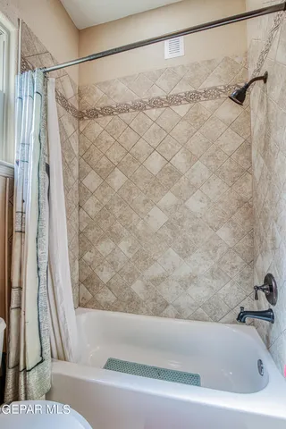 a spacious bathroom with a granite countertop sink and a toilet
