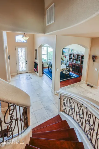 a view of a terrace with lawn chairs