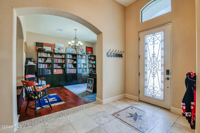 a living room with furniture and kitchen view