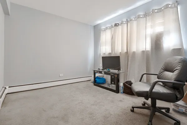 a view of a livingroom with workspace and a window