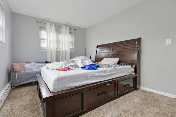 a bedroom with a bed and a dresser