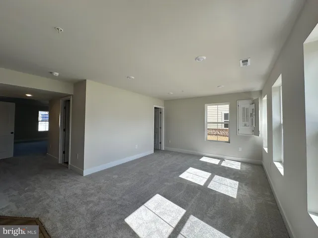 an empty room with windows and entrance